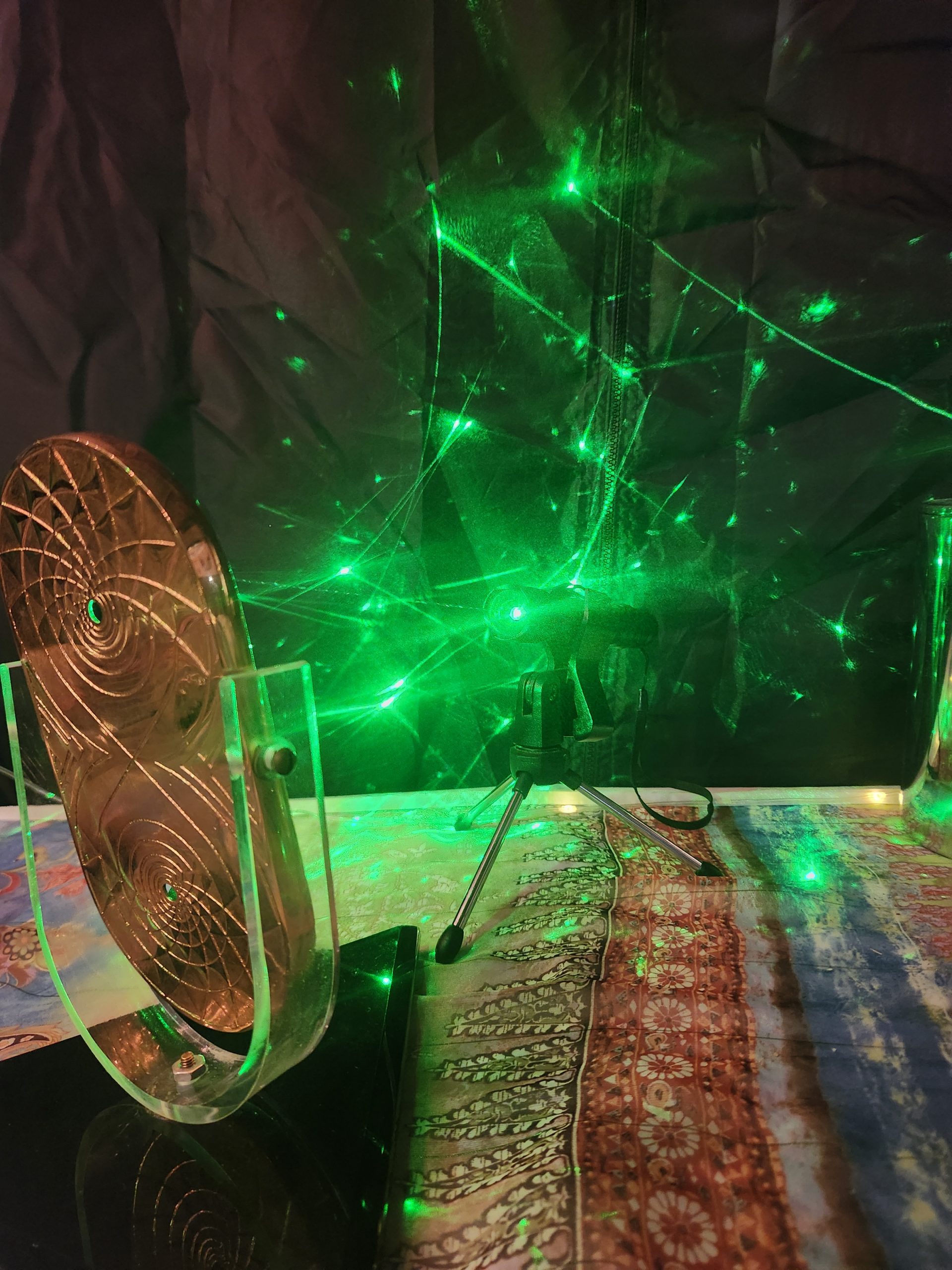 Green coherent laser light moving across a gold pyramid structure