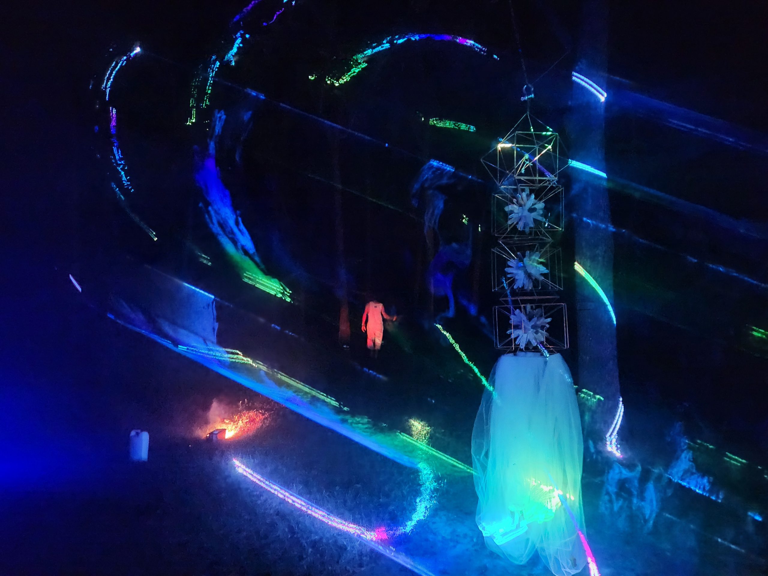 Laser light sweeping around the crystal tower at New Earth Music Fest