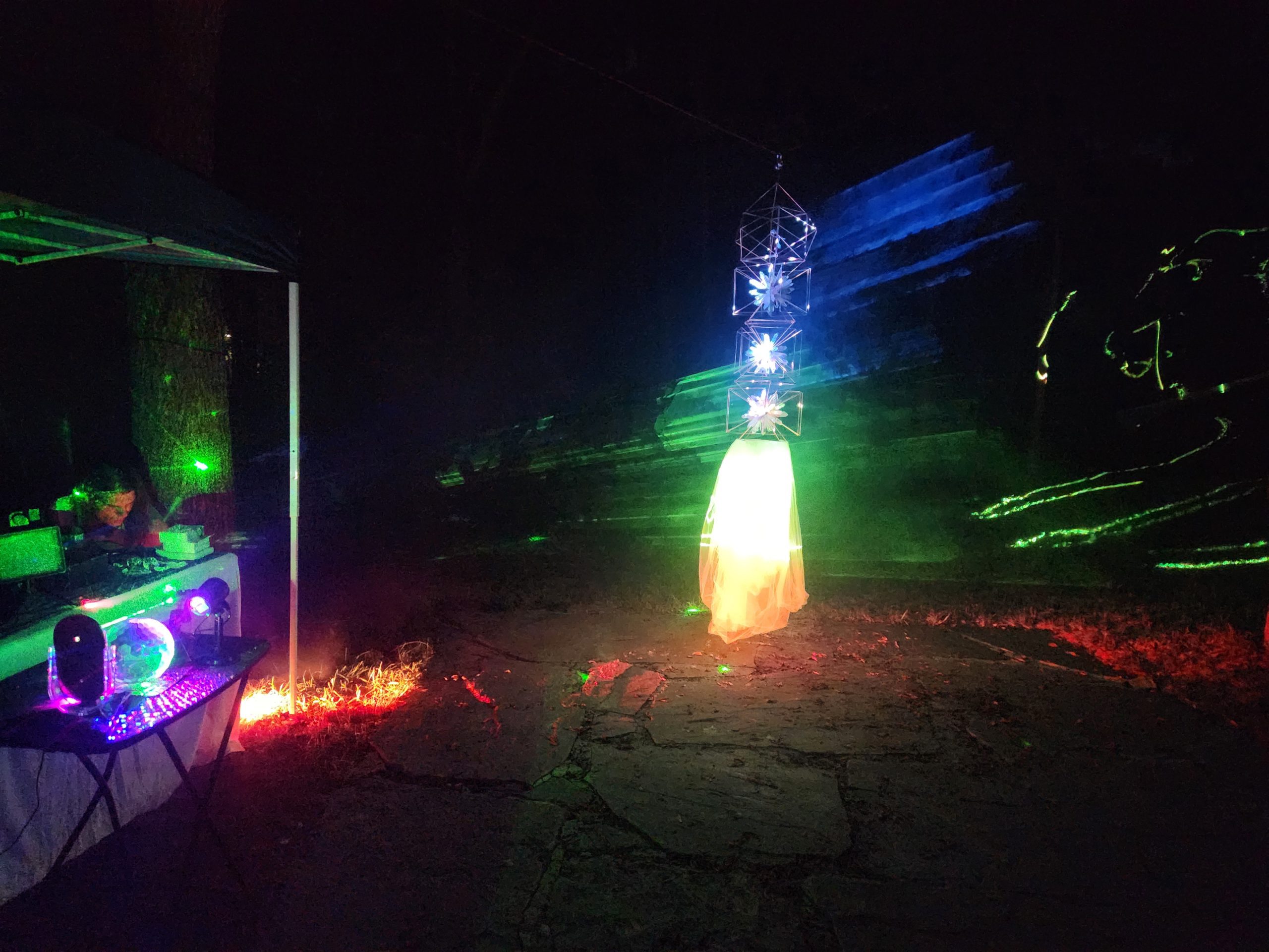 Glowing crystal tower beside the wellness station at night