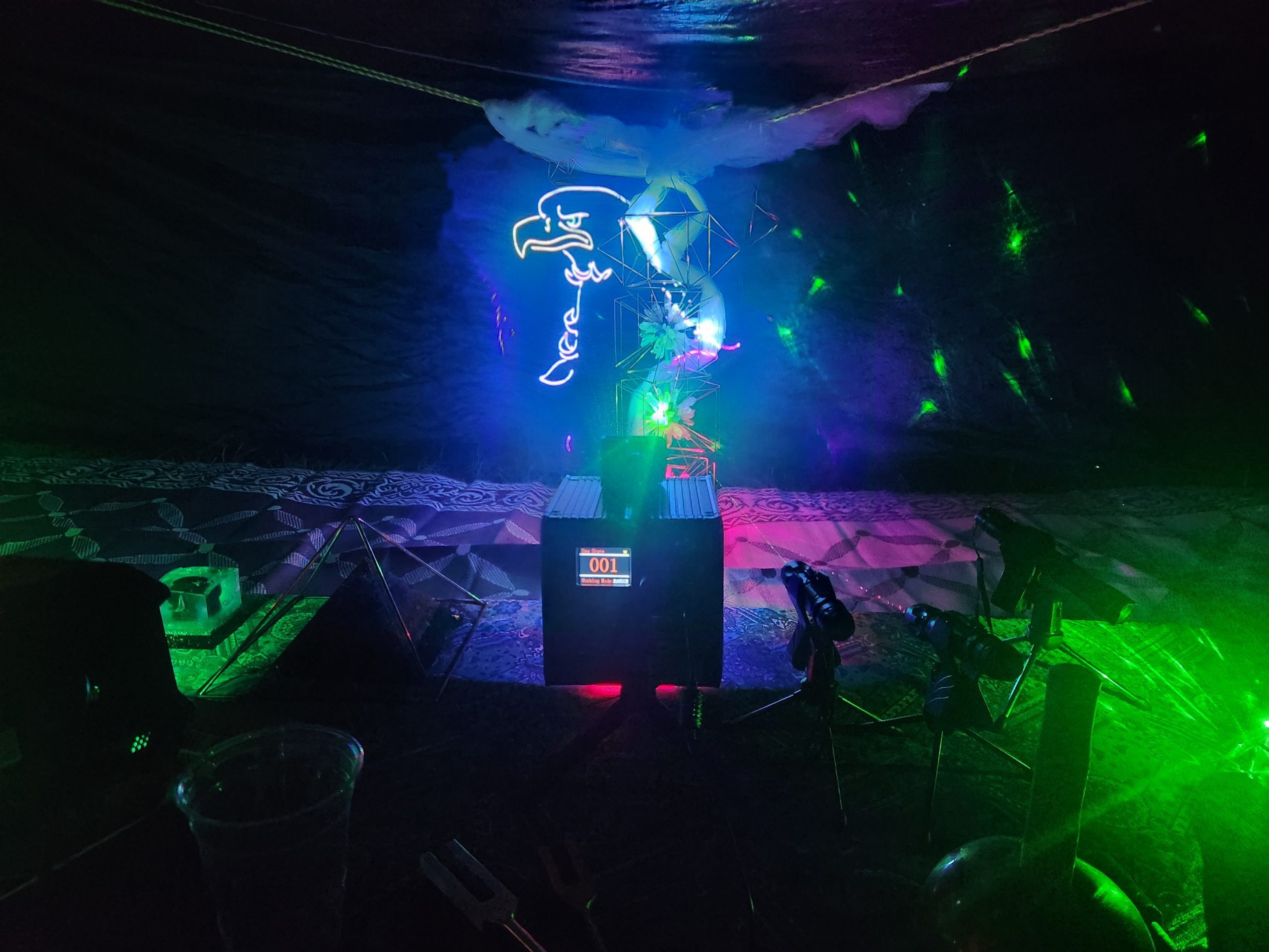 Laser animation projected over a crystal installation inside the wellness tent